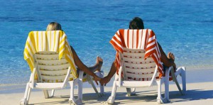 Couple Holding Hands on Beach Chairs
